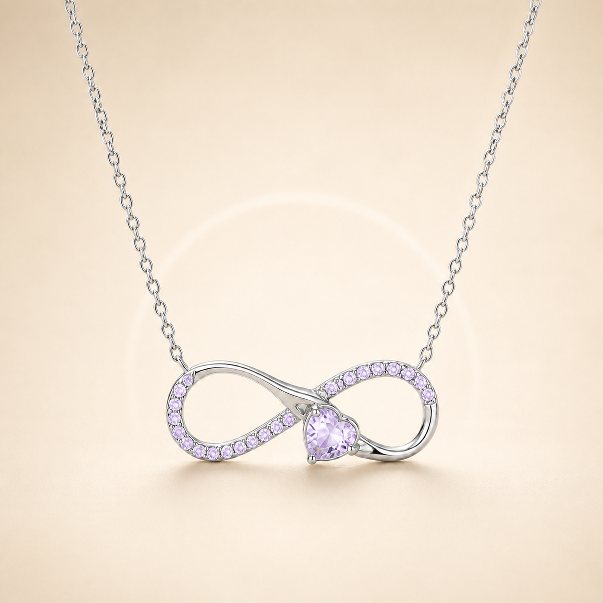 Infinity heart silver necklace on a tonal warm ivory background
